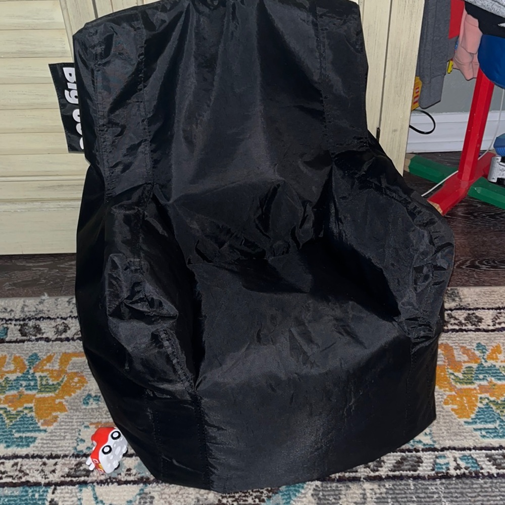Big Joe kids mini bean bag chair. Solid black with side pocket.